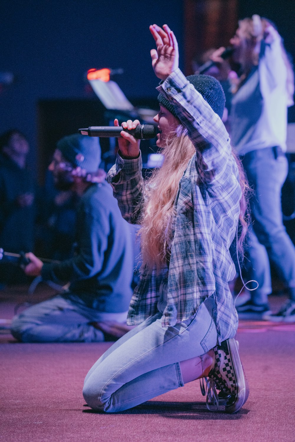 kneeling woman while singing