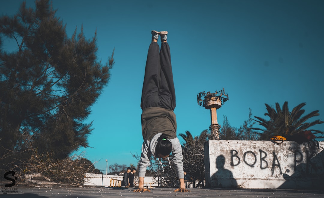 man doing hand stand during daytime