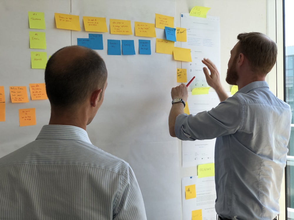 man in gray shirt facing sticky notes