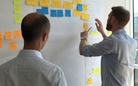 man in gray shirt facing sticky notes