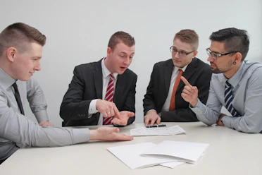 Professional office setting with a team discussing property assets and documents