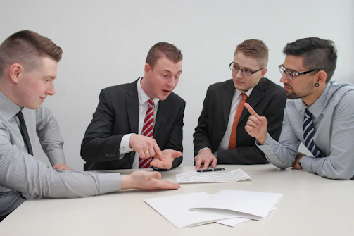 Office meeting with legal advisors discussing compliance strategies.