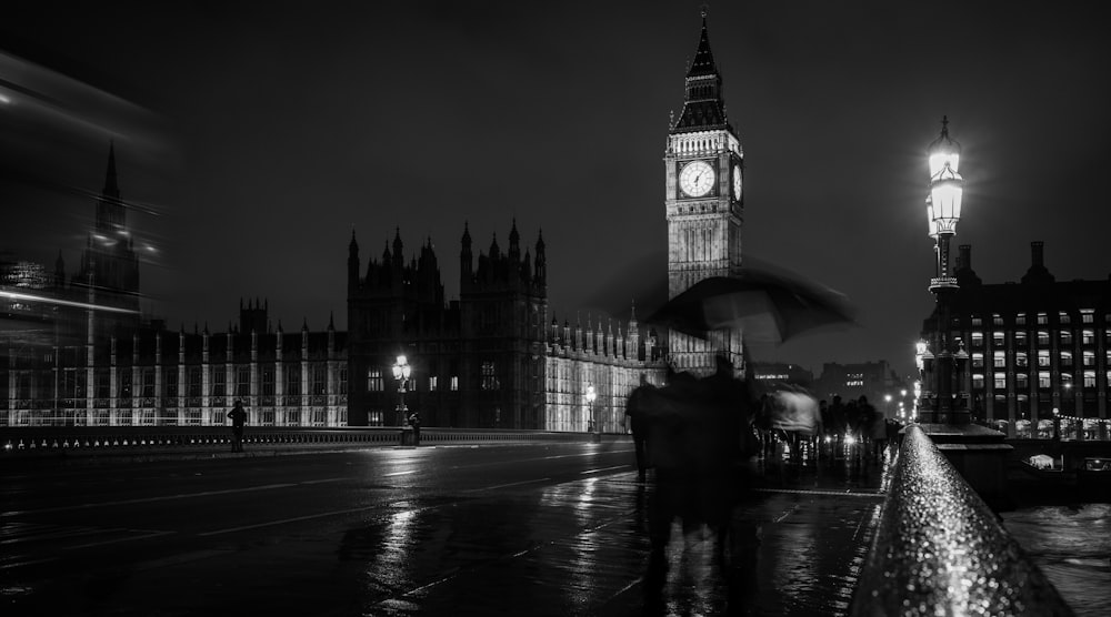 a black and white photo of a person holding an umbrella