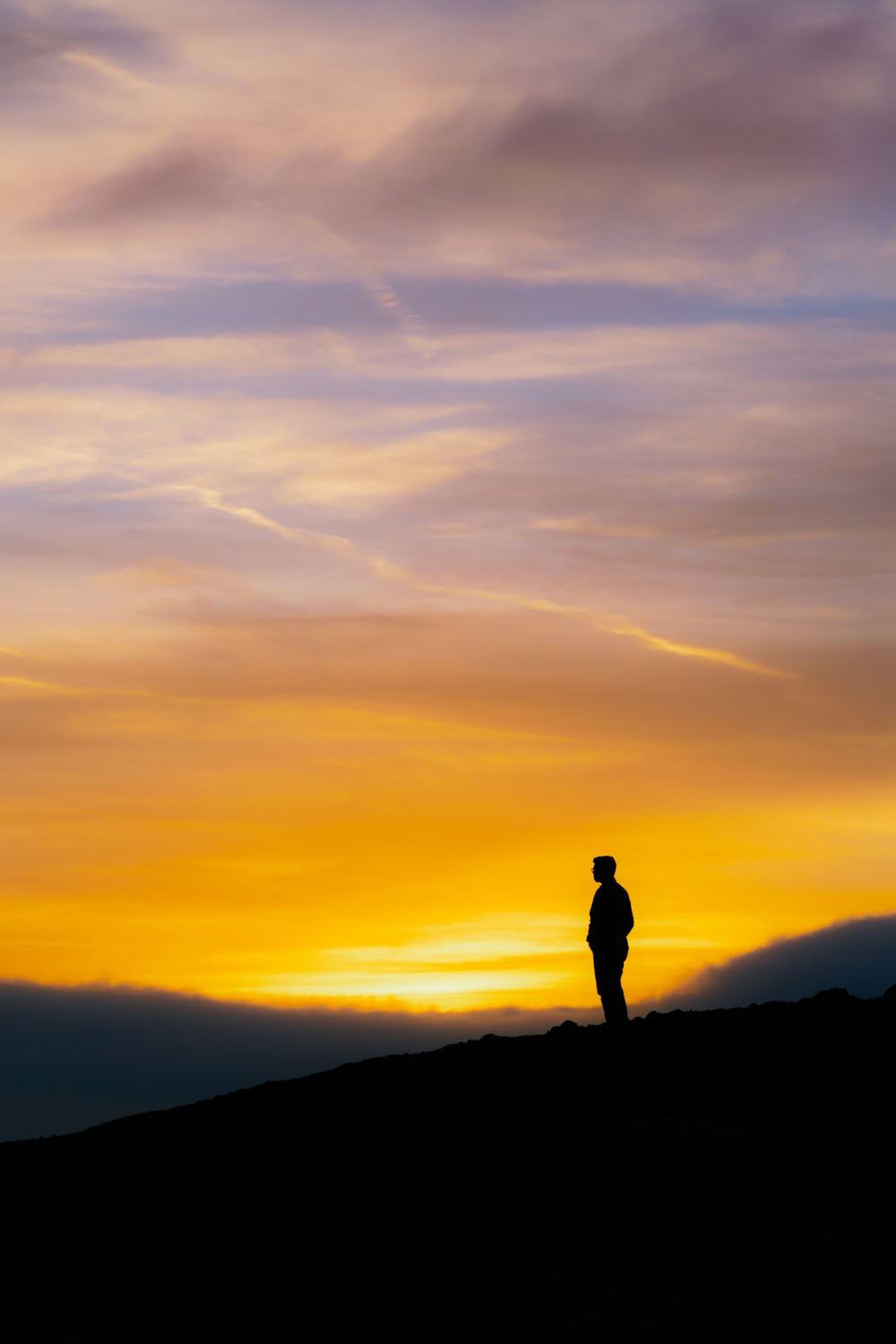 silhouette of man on top of mountain