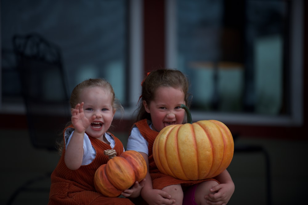 two girl holding squash