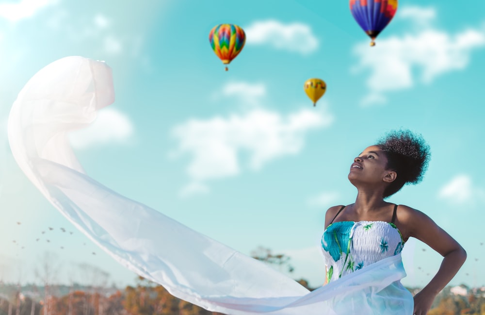 woman looking at hot air balloons