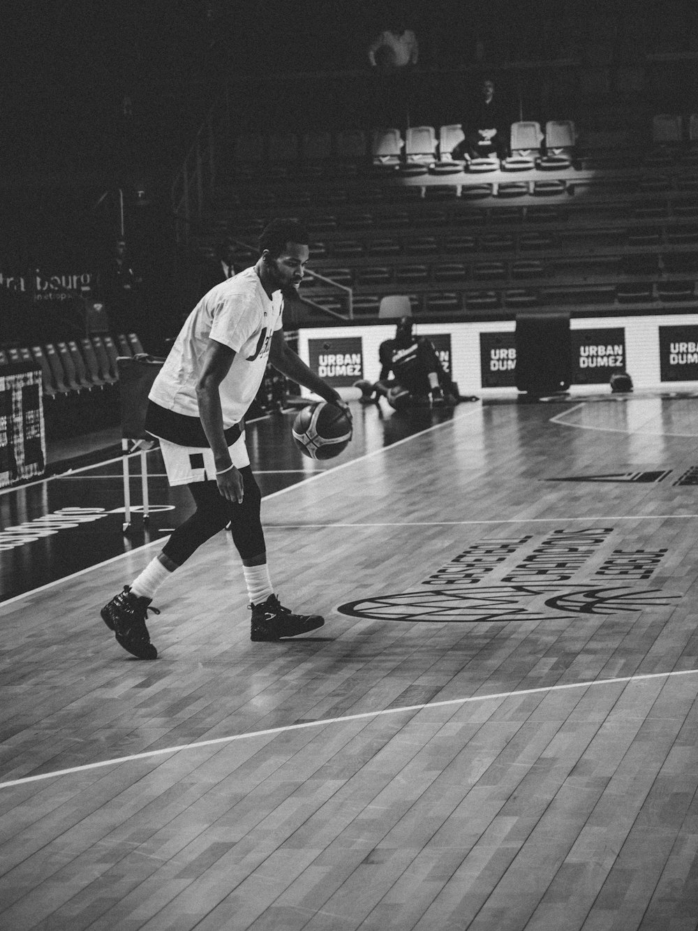 grayscale photography of man playing basketball