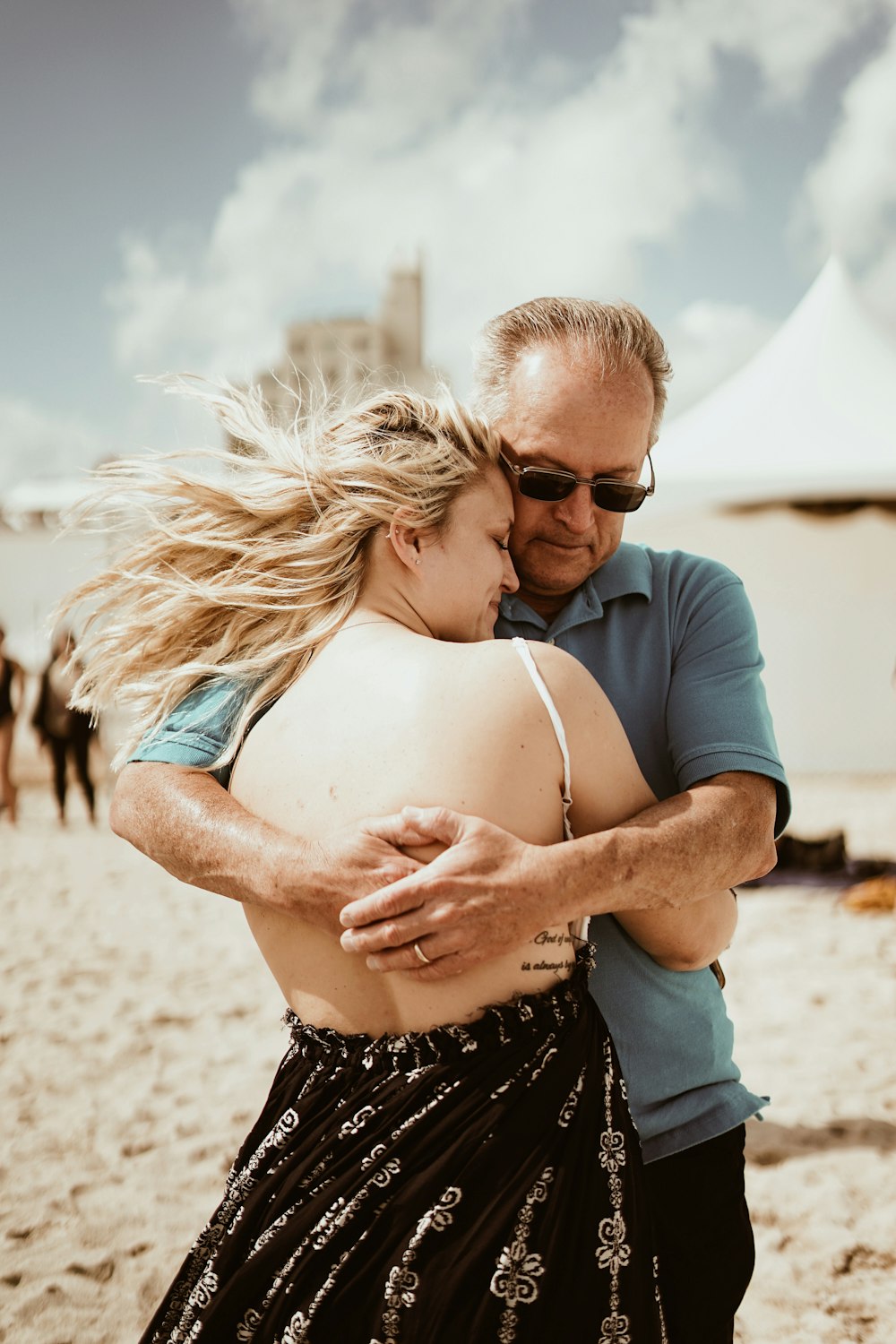 man hugging woman