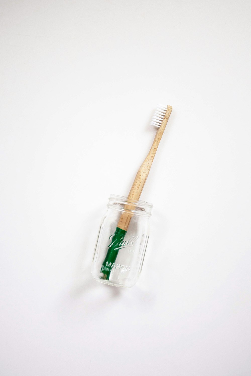 brown toothbrush in jar