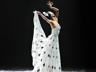 An elegant dancer posing in a beautifully decorated dressing room.