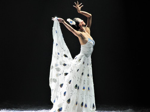 An elegant dancer posing in a beautifully decorated dressing room.
