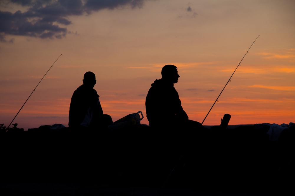 silhoette of man fishing