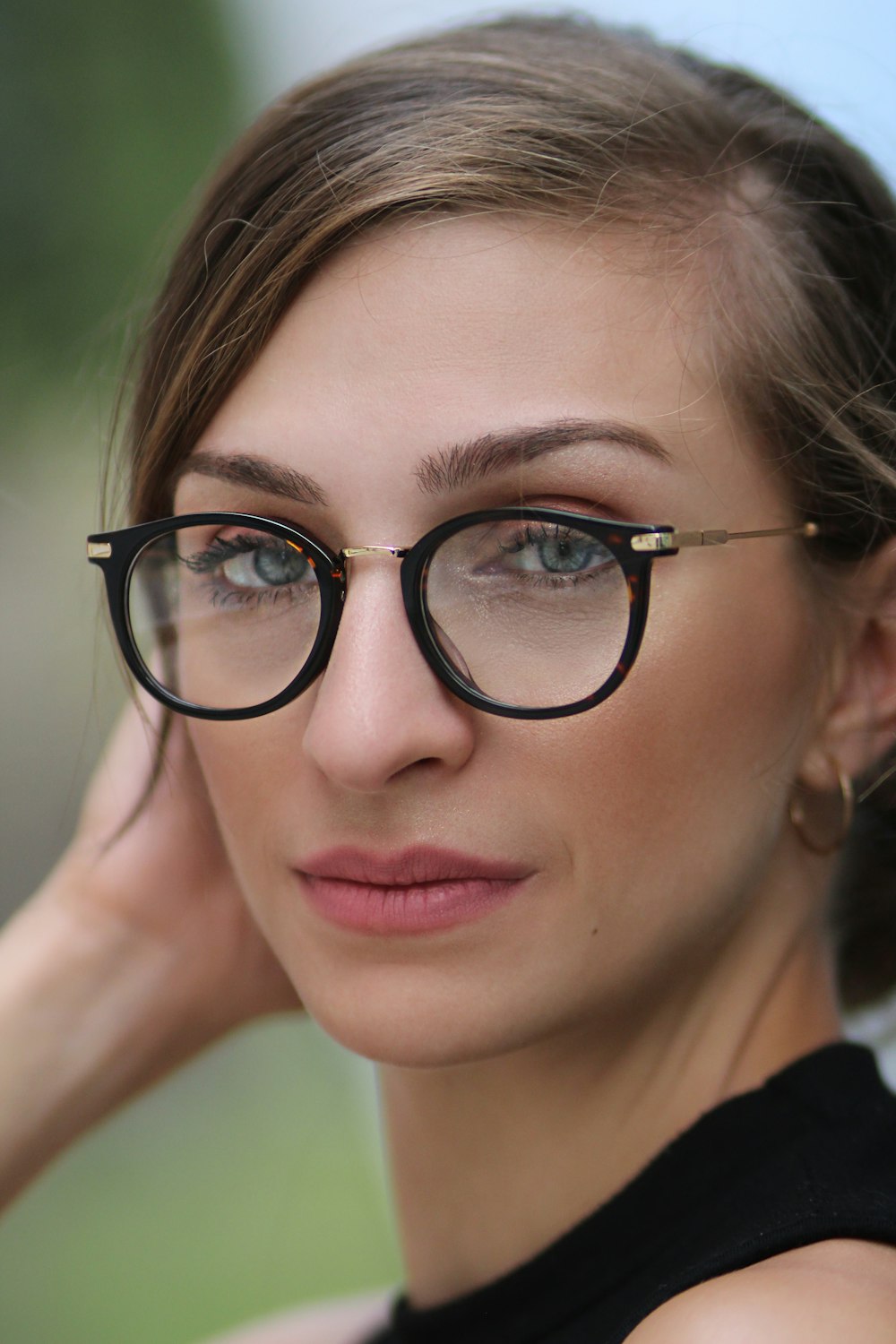 portrait photography of woman wearing eyeglasses