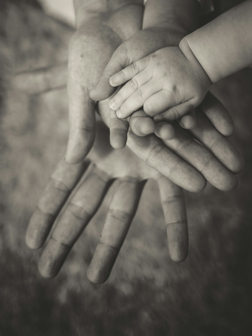 person holding baby's hand