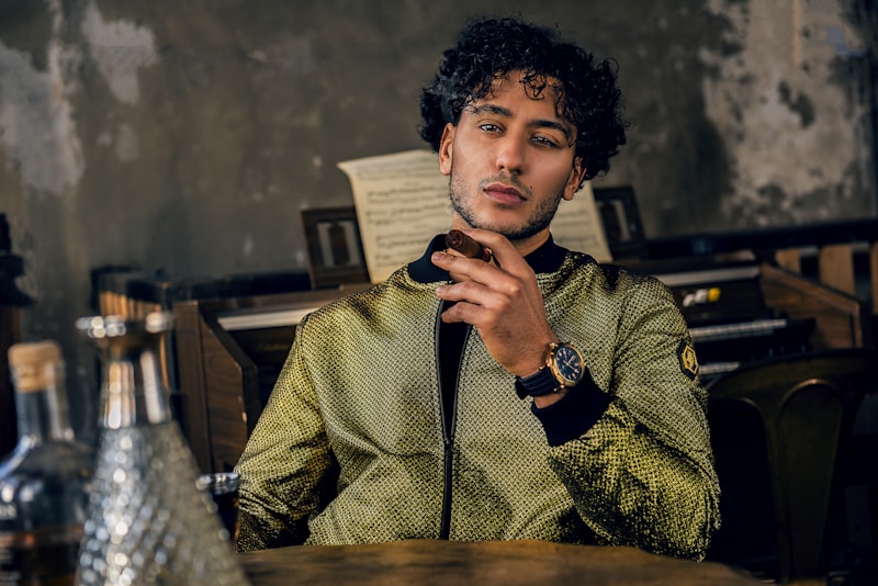 man sitting while smoking