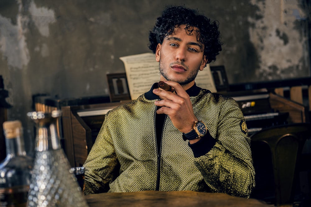 man sitting while smoking