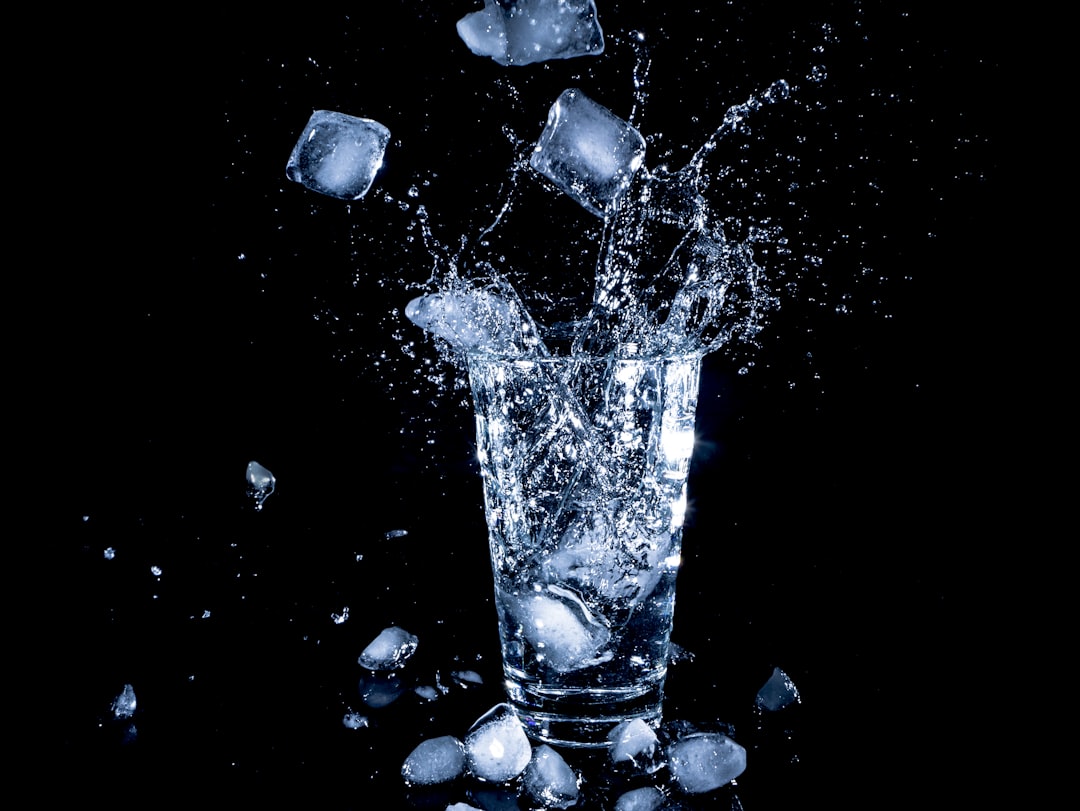 ice cubes dropped in clear drinking cup with water, Icecubes