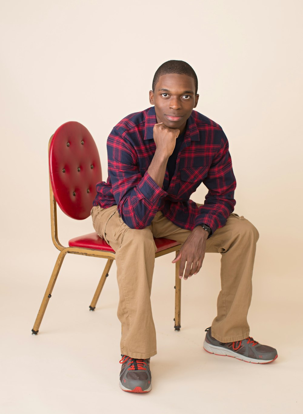 man wearing sport shirt sitting on chair