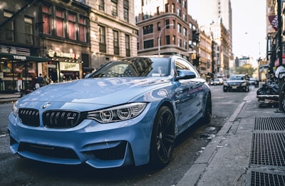 blue bmw coupe parked on the road during daytime bmw teams background