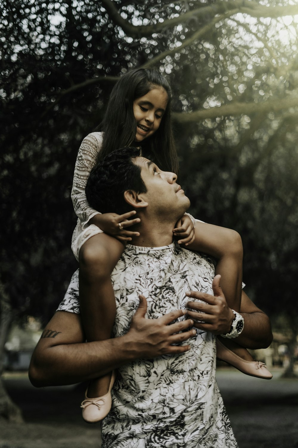 girl riding on his father's back