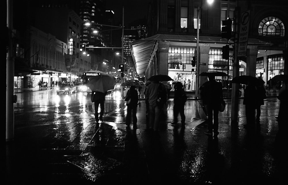 grayscale photography of people crossing on streets