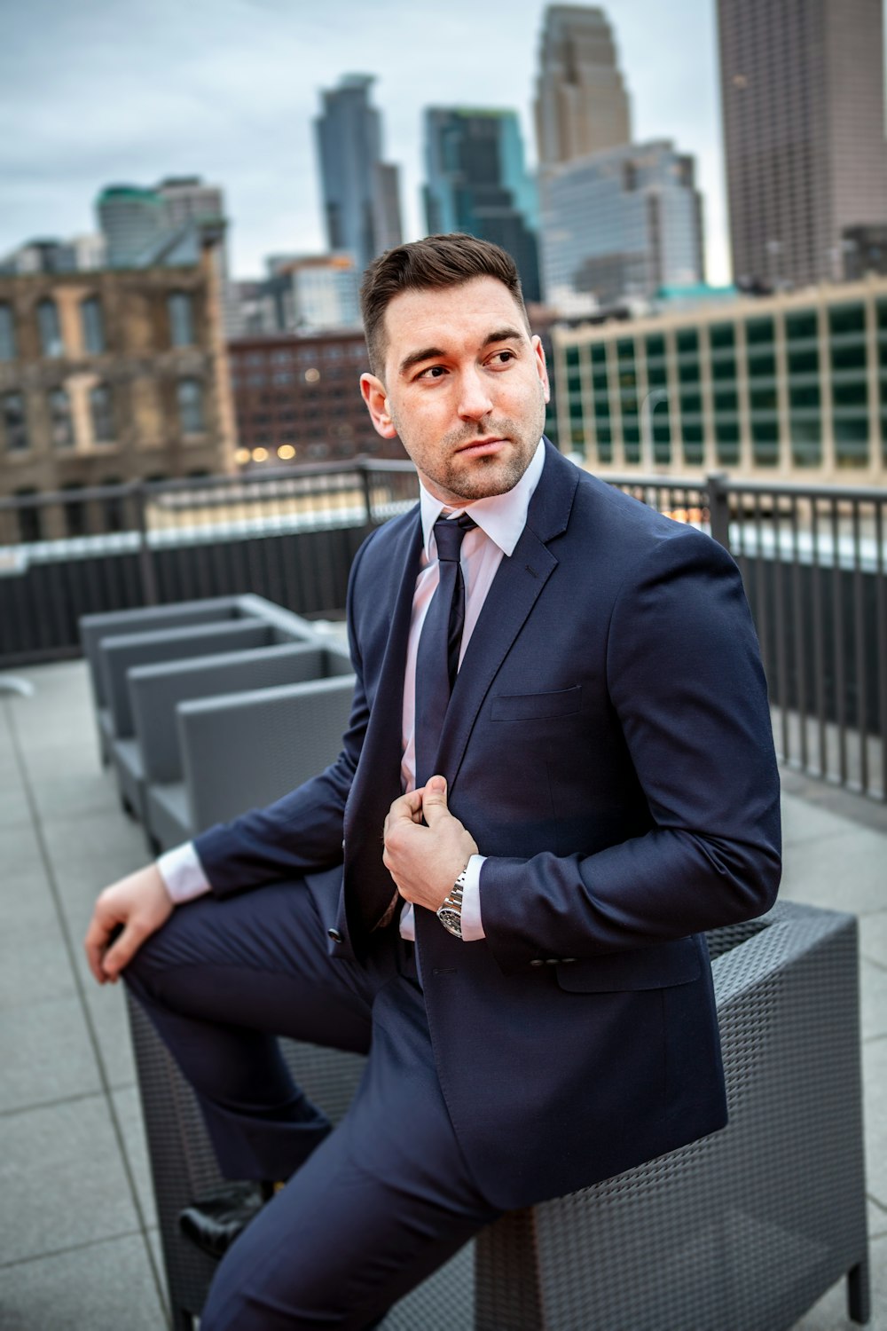 man in suit jacket sitting down