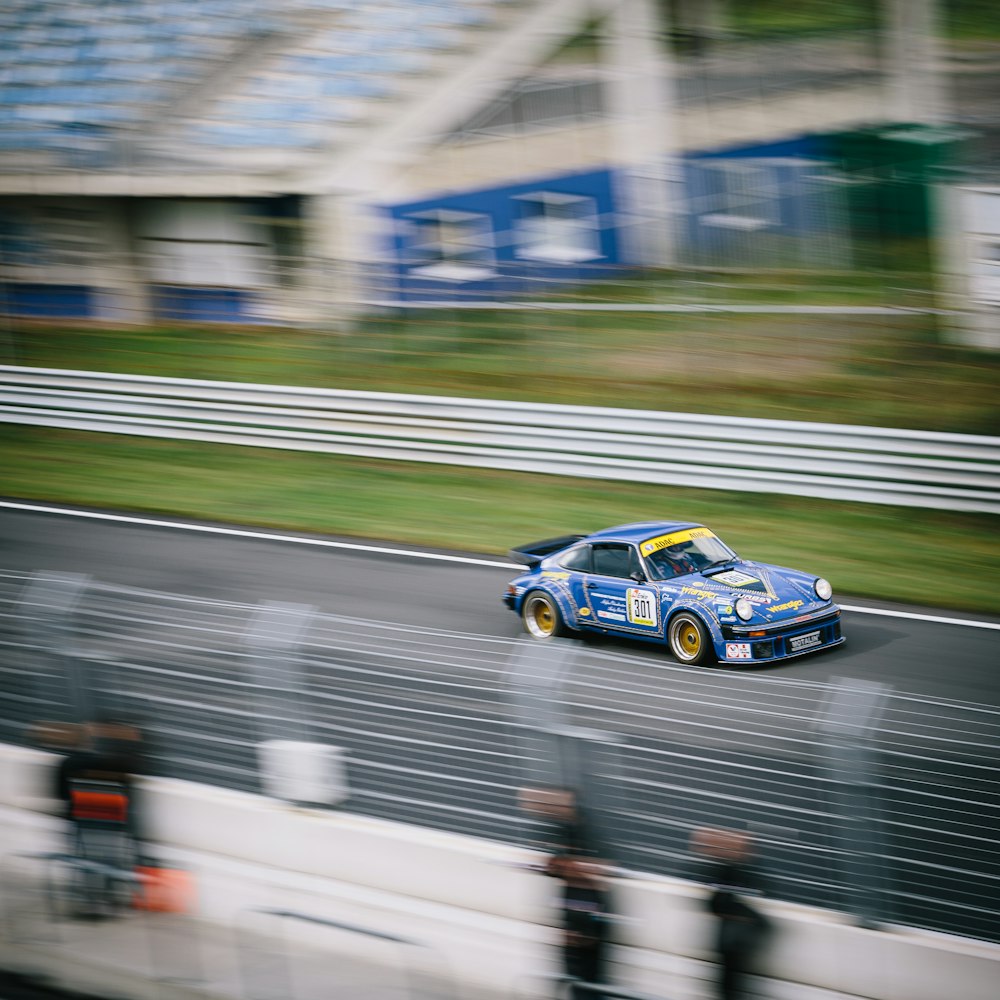 blue NASCAR car on paved road