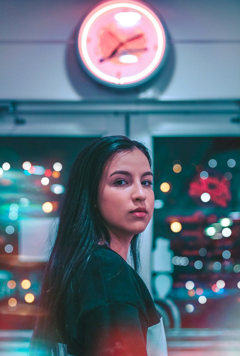 woman standing near analog clock