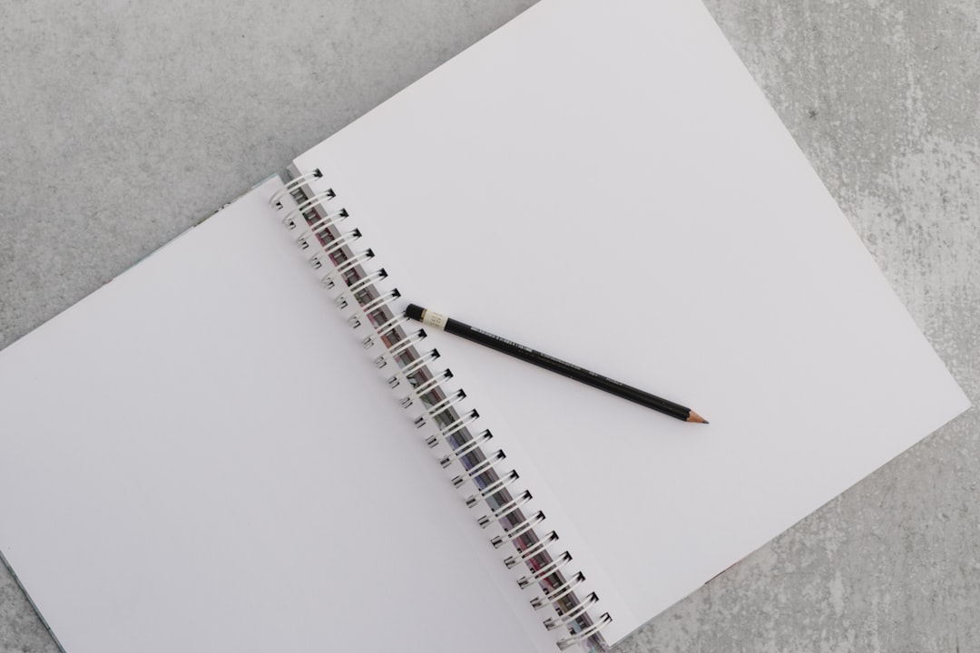 a notebook with a pencil on top of it