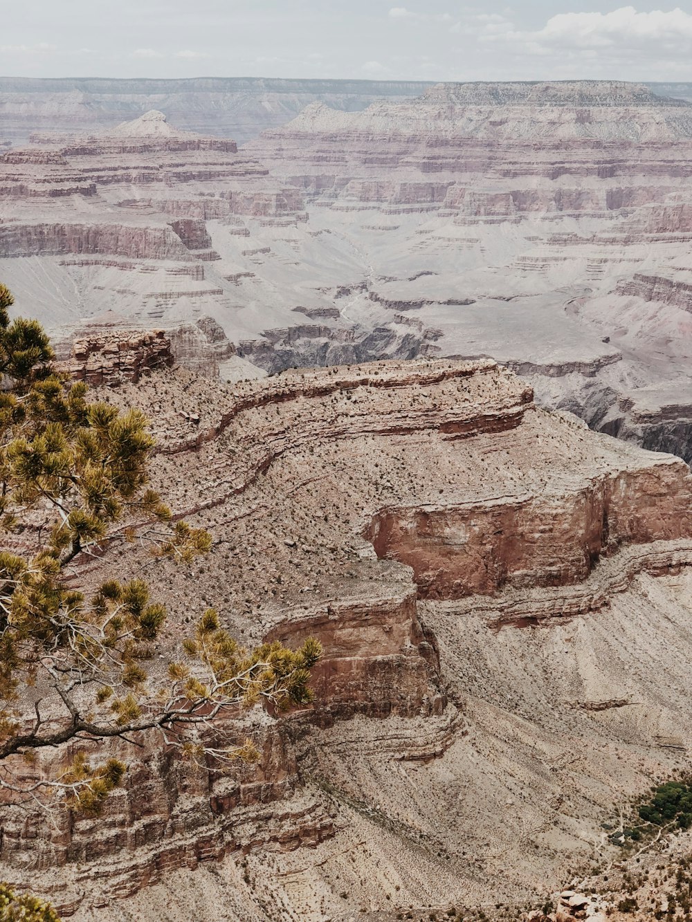 brown rock formation under white clouds during daytime