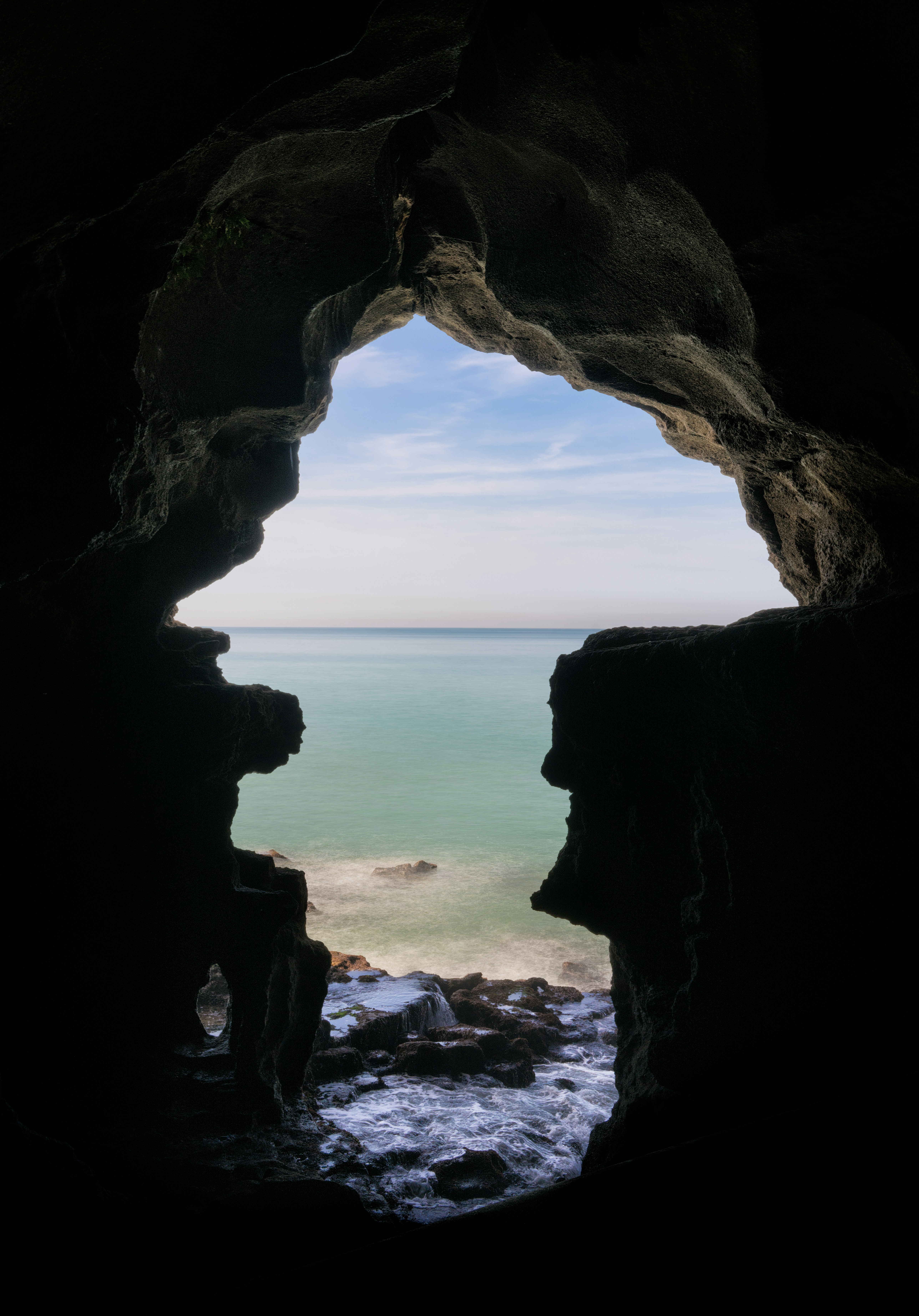 body of water near cave