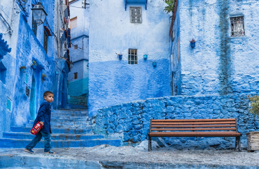 boy standing beside bench