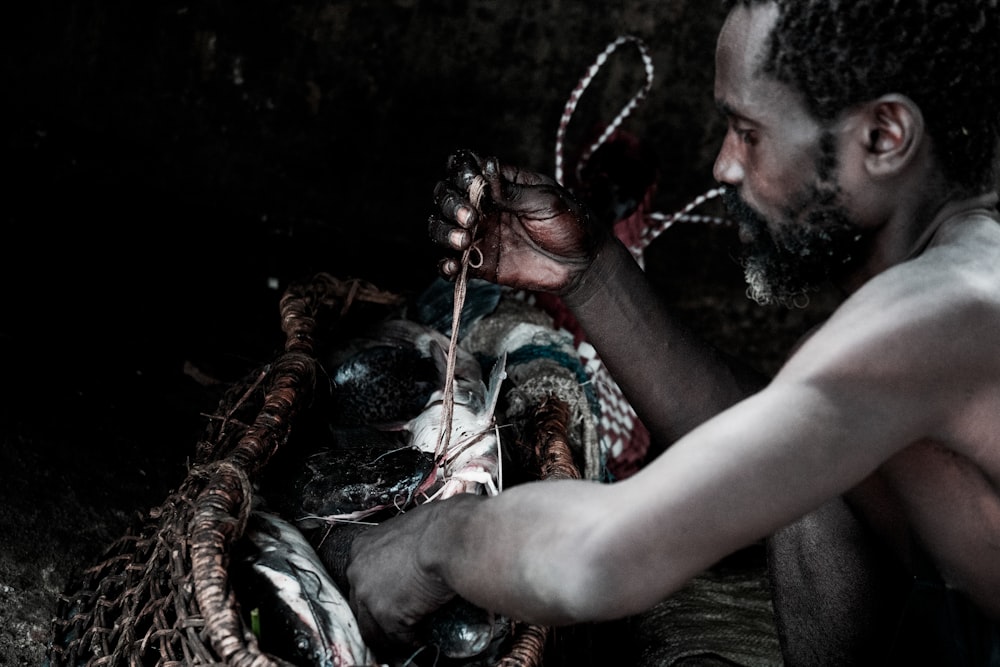 man working on fishing net