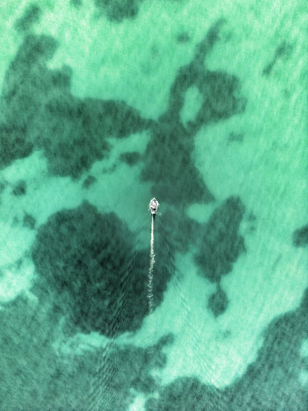 an aerial view of a boat in the water