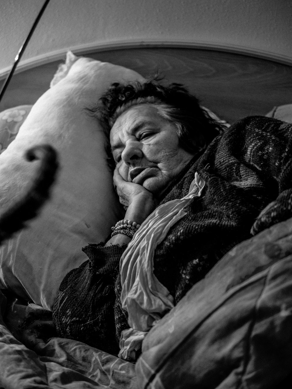 gray scale photo of woman lying on bed