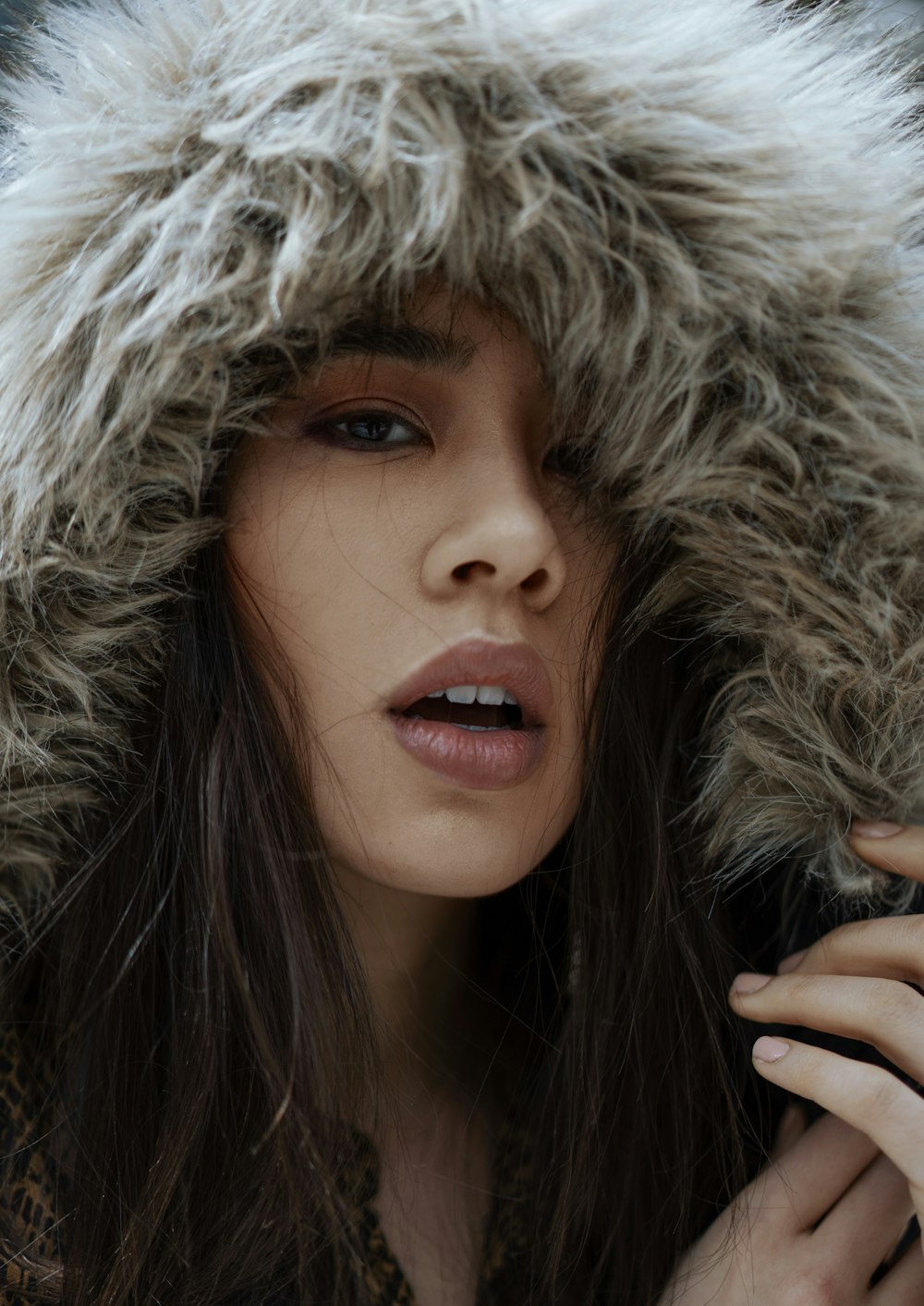 shallow focus photo of woman in gray fur hoodie