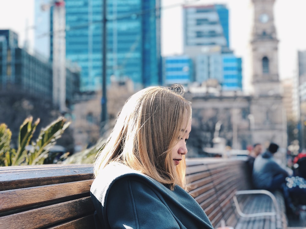 woman sitting on brown bench