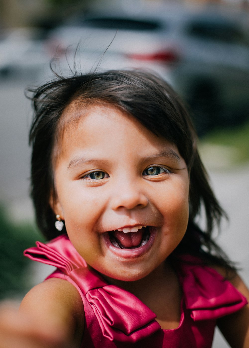 smiling girl wearing red tank top during daytime