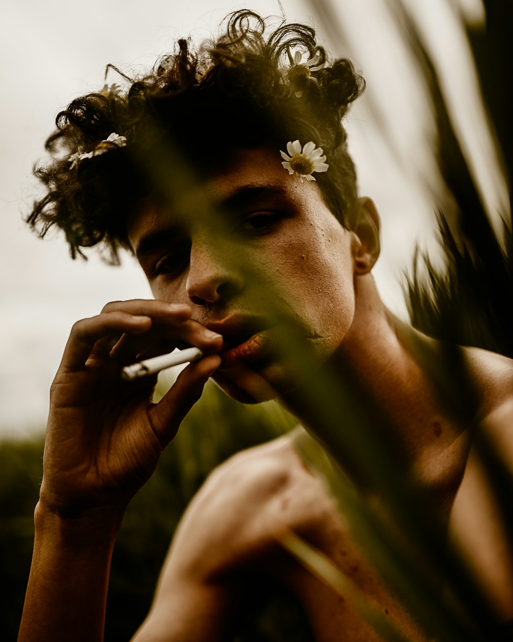 topless man holding cigarette