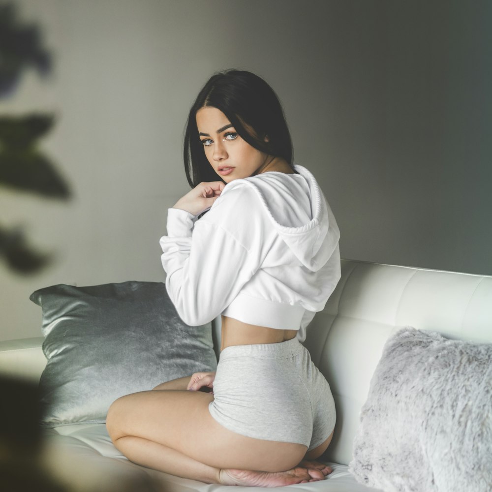 Woman wearing white pullover hoodie and grey boyshorts on sofa photo – Free  Lounging Image on Unsplash