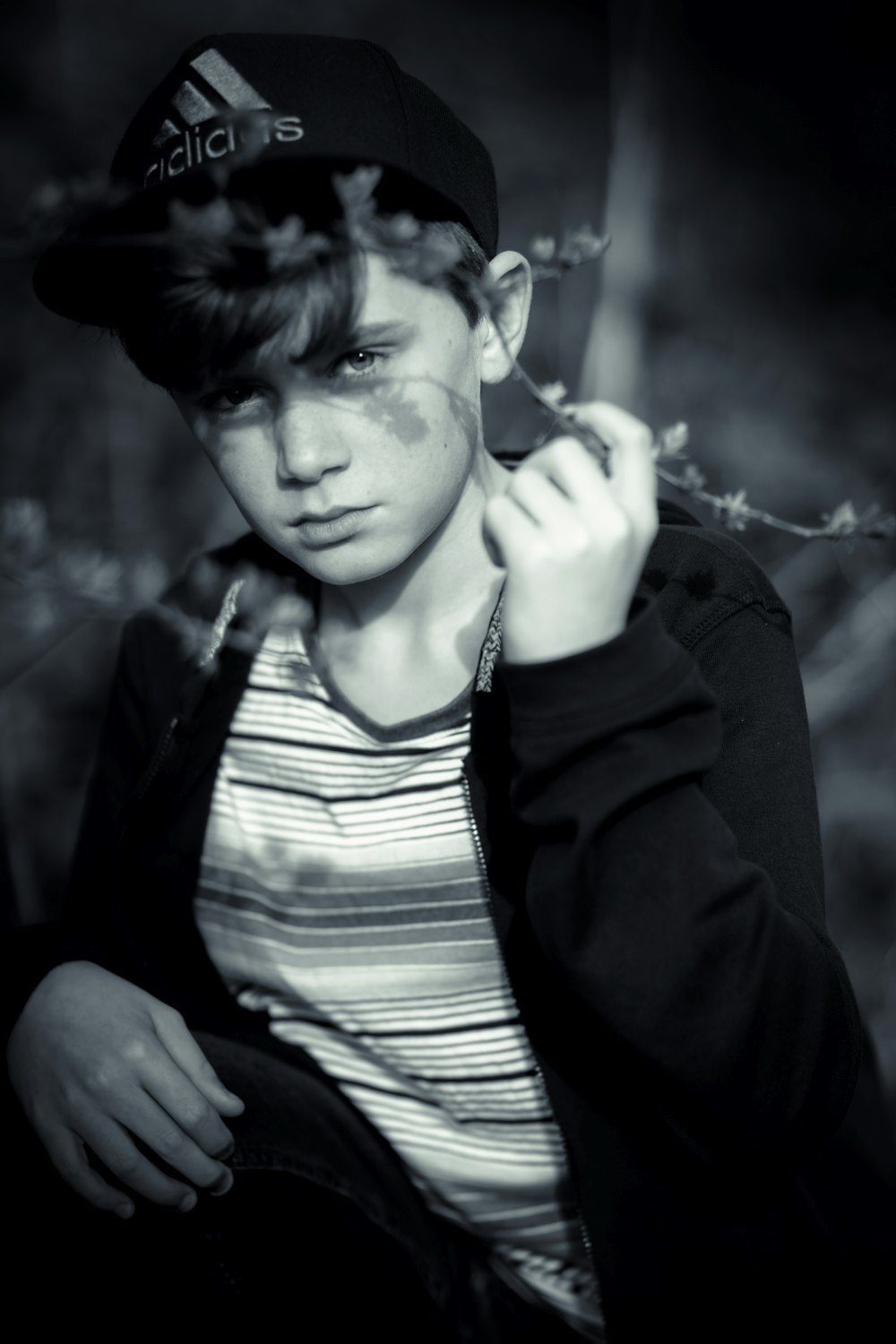 a young man with a baseball cap is posing for a picture