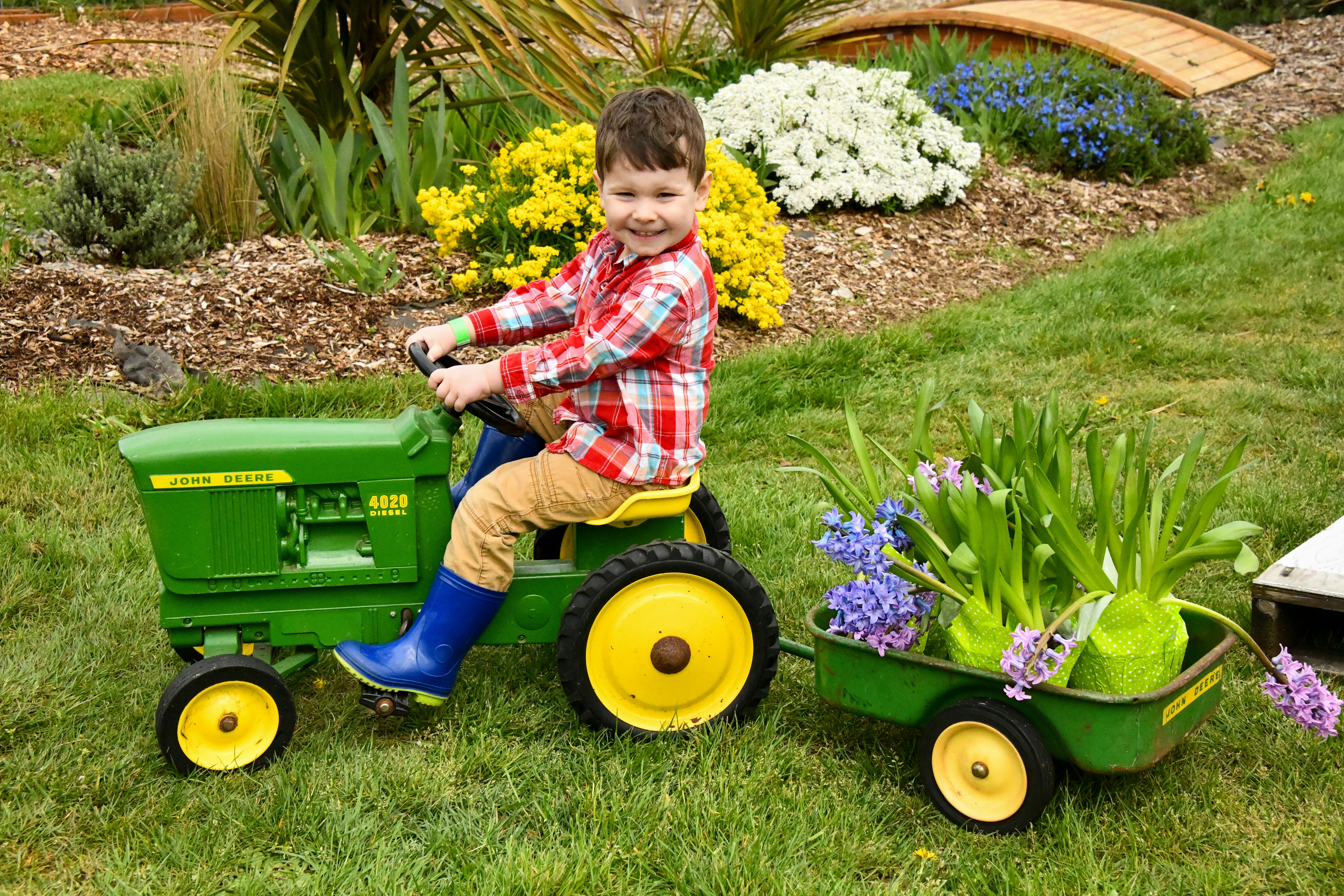 boy riding riding mower toy