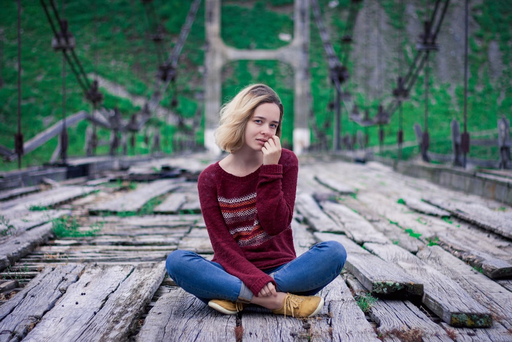 woman sitting on bridge