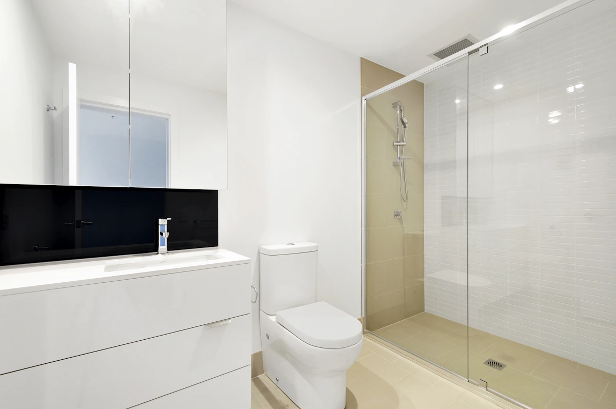 Bright modern bathroom interior with tiled walls and a toilet area, the kind of space where a grab bar is typically installed