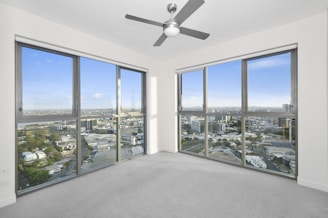 Empty commercial office space with large windows and city view