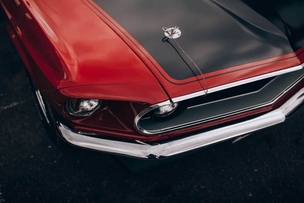 close-up photography red and black muscle car hood