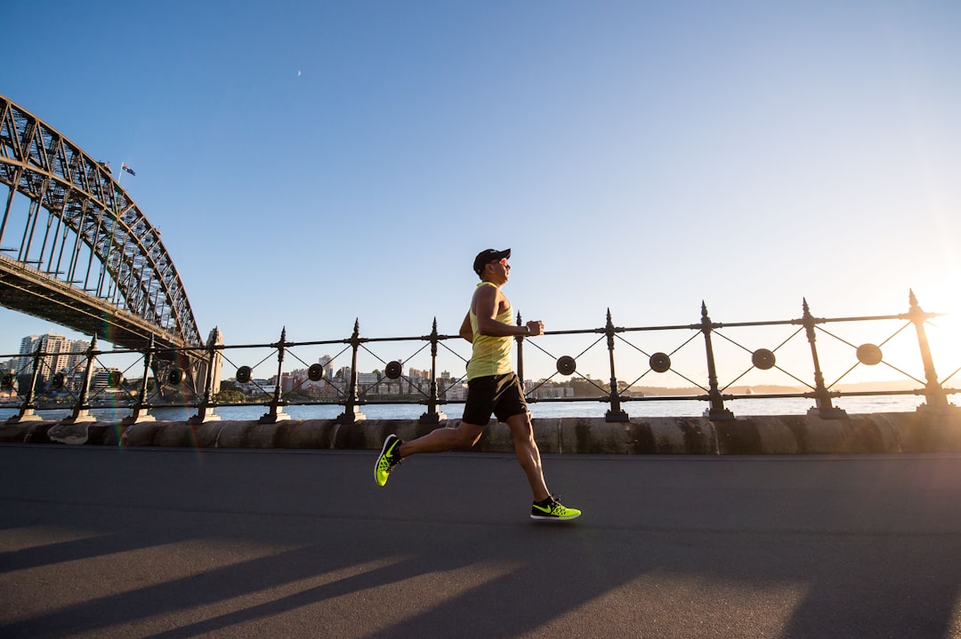man running along a riverfront
