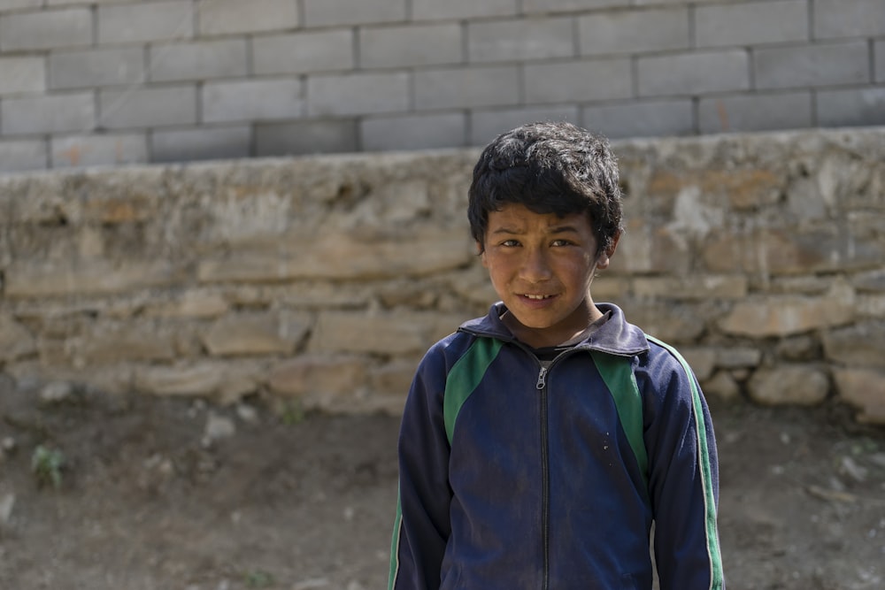 boy in blue jacket on focus photography