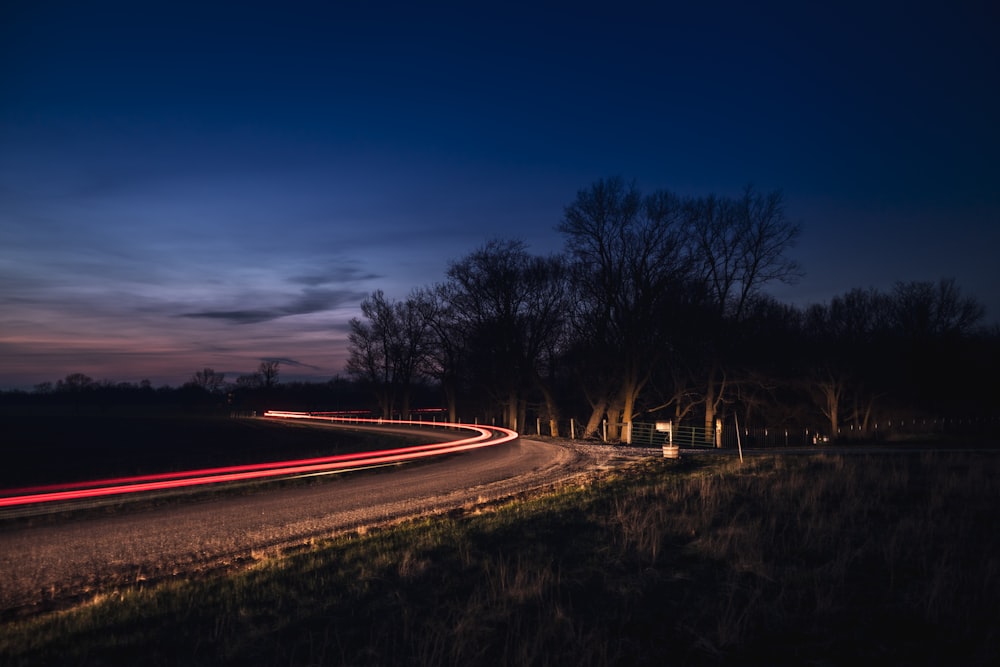 time lapse photography of road under blue sky