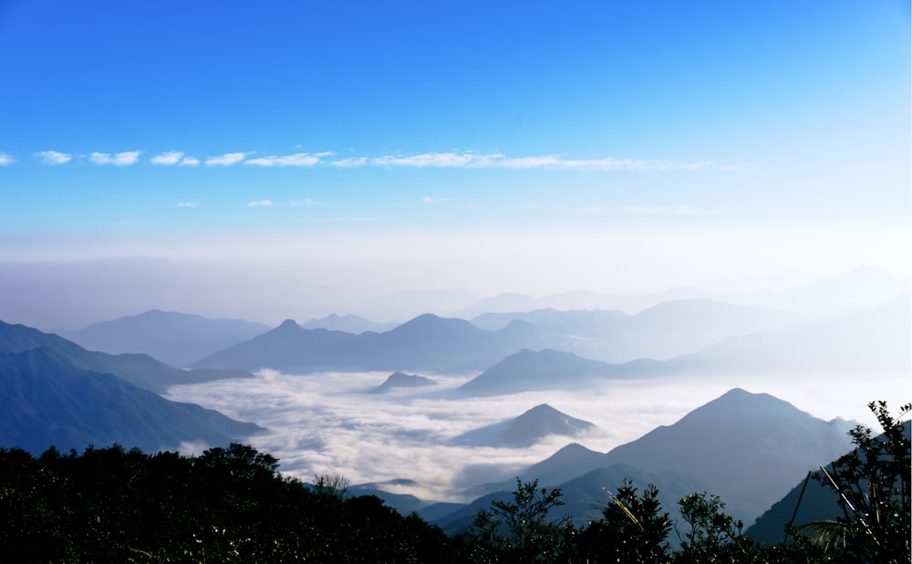 mountains near clouds under blue sky